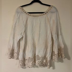 Lace embroidered top, with bell sleeves. Sleeves have side slits. EUC